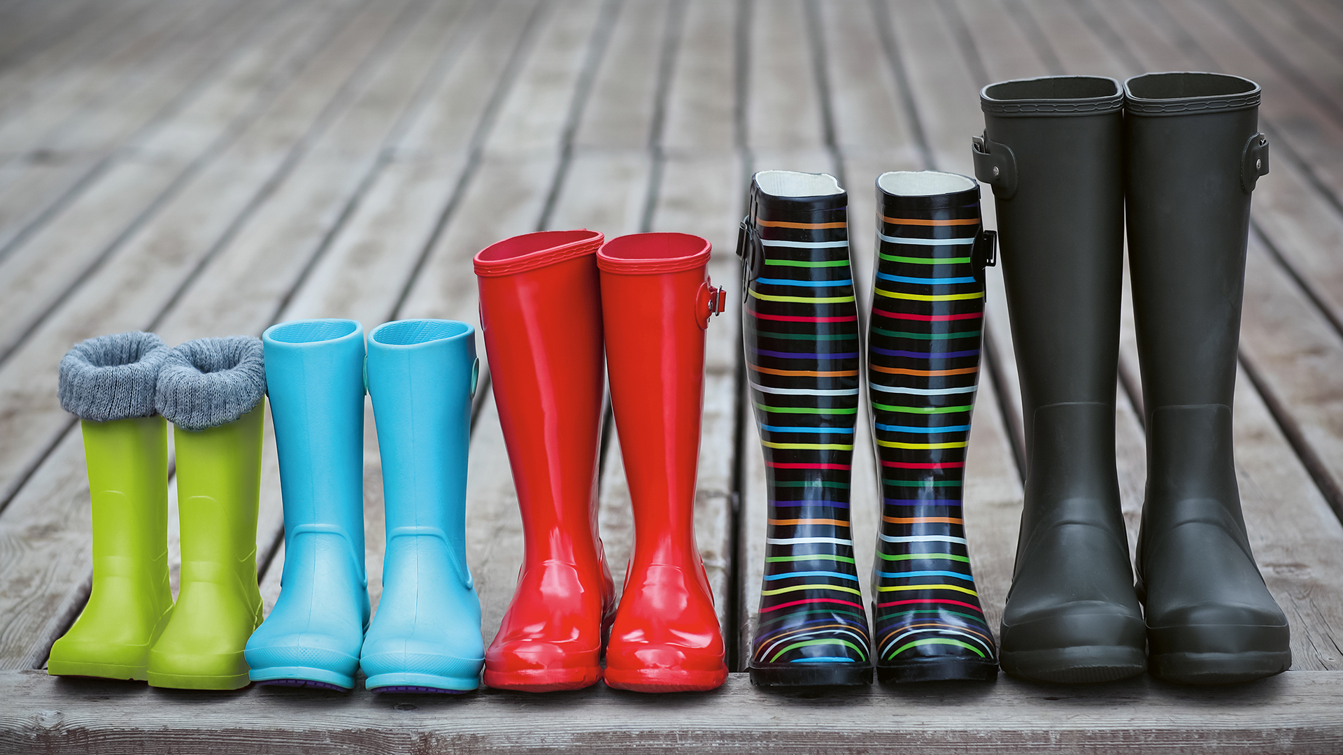 Ansammlung von unterschiedlichen Gummistiefeln, die eine Familie symbolisiert.